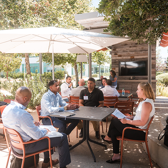 Viasat employees working at an outside conference room in Carlsbad, CA